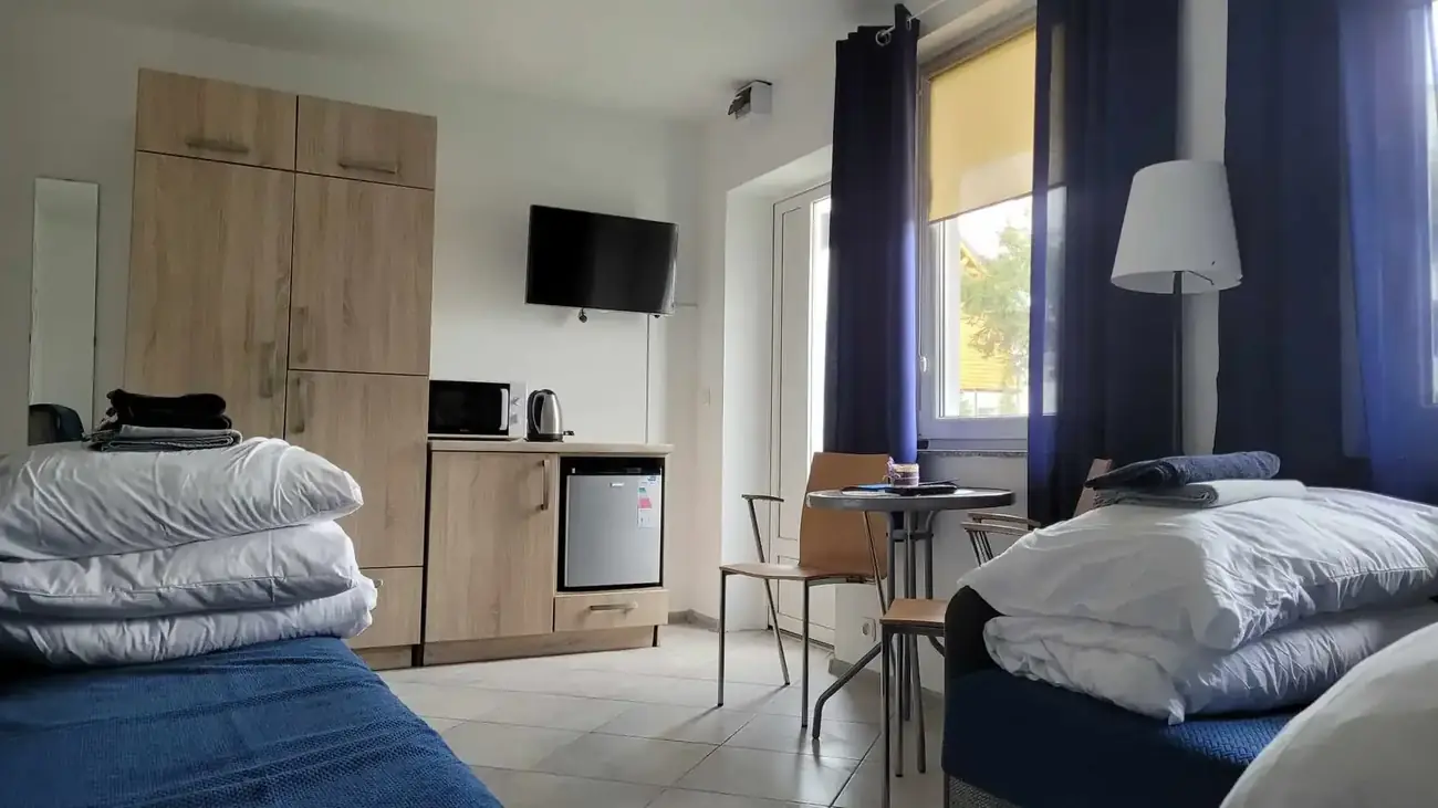 Pokój wakacyjny z łóżkami, lodówką, telewizorem i stolikiem, Zatoka Cydrowa w Stegnie